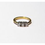 Diamond three-stone ring, brilliants totalling '.5', in 18ct gold, size K.