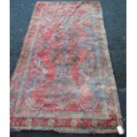 Turkoman rug with four medallions over red ground, spandrels and floral border, 265cm x 136cm.