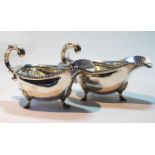 Pair of sauce boats of Georgian style with gadrooned edges and flying scroll handles, London and