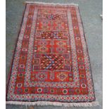 Kurdish Quchan rug with three H panels with arrows over orange ground, all over guls and rosettes,