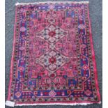 Hamadan rug with two central medallions over floral pink ground, triple border, 120cm x 95cm.