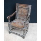 Jacobean carved oak armchair with floral panelled back, open down-swept arms, block and baluster
