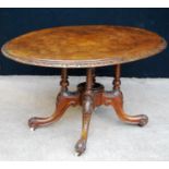 Victorian walnut loo table with oval inlaid top, floral carved moulding, raised on baluster quad