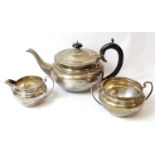 Silver three-piece tea set of compressed shape with bead edges, Birmingham 1931, 19oz.