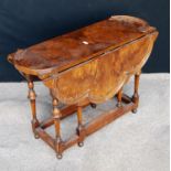 Queen Anne style burr walnut gate-leg table, the scalloped drop-flap top raised on baluster turned