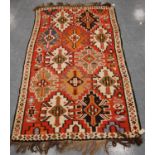 Shirvan Kilim with star design over faded red ground and diamond border, 300cm x 167cm.