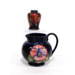 Small Moorcroft vase decorated with fruit over blue ground, signed to the base, 9cm high; together