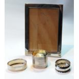 Silver photograph frame, for image 5½in x 3½in, 1903, and three napkin rings.   (4)