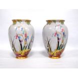 Pair of Carlton Ware vases, each decorated with bluebells, primula, snowdrop and hedgerows, marks to