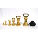 Set of six Avery brass graduated weights, including a set of Victor stacking weights, 18cm high.