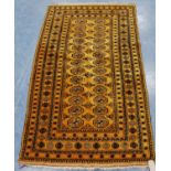 Afghan rug with two rows of thirteen guls over orange ground and star border, 196cm x 110cm.