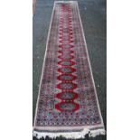 Persian runner with single row of twenty-four guls over beige ground, triple border, 432cm x 81cm.