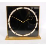 German Art Deco brass desk clock with black face, white chapter ring and eight day clockwork