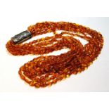 Butterscotch amber necklace of seven strands on silver snap, gross 181g, snap approximately 60g.