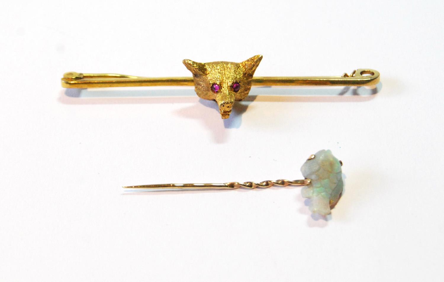 9ct gold pin with fox head, 1947, and a scarf pin with carved opal fish.   (2)