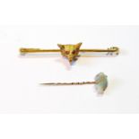 9ct gold pin with fox head, 1947, and a scarf pin with carved opal fish.   (2)