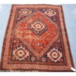 Kashgar rug with central rosette and diamond star spandrels and border, 197cm x 158cm.