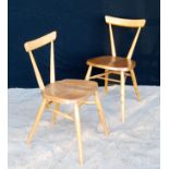 Pair of Ercol side chairs, each with tablet top rail, splayed tapering turned supports and legs