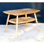 Ercol coffee table with rounded rectangular top, pierced handles, raised on splayed turned legs