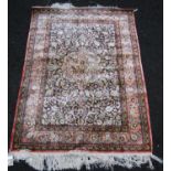 Persian silk rug with central floral medallion, all over floral pattern and borders, 155cm x 108cm.