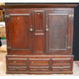Georgian oak hall cabinet, the projected moulded cornice over panelled doors over stepped base