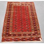 Tekke rug with three rows of thirteen guls over red ground and multiple border, 184cm x 123cm.