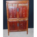 Chinese cabinet on stand of rectangular form with carved panelled doors, raised on block feet, 104cm