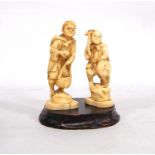 Pair of early 20th century Japanese carved ivory figures, one carrying a basket, the other a drum,