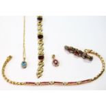 9ct gold bracelet with garnets, another, baguette rubies, a similar brooch and two gem pendants.