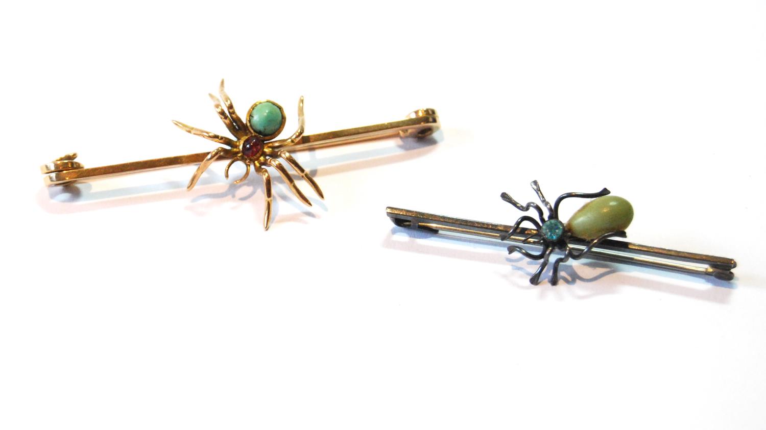 Gold safety pin with a spider set with ruby and turquoise and another, similar, silver.   (2)