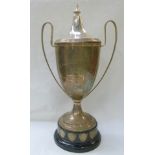 Large silver trophy cup with reeded edge and loop handles, the cover with turned finial, "The