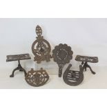 Four Victorian cast iron grate trivets incl. one of horseshoe form inscribed "Good Luck" and one