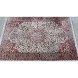 Modern Eastern style rug, the cream field with central medallion and vases of flowers to each end,