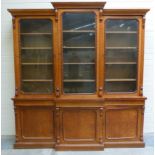 Victorian oak breakfront bookcase, the upper section enclosed by three glazed doors with cupboards