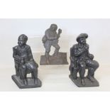 Pair of Victorian black painted cast iron doorstops or half ornaments depicting two seated men