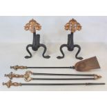 Pair of Art Nouveau wrought iron firedogs with pierced copper lobed foliate finials on stippled