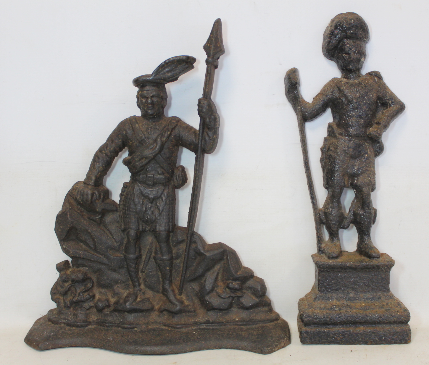 Late 19th/early 20th century cast iron doorstop of a kilted highlander with spear standing on a