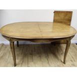 Continental inlaid oval dining table with additional leaf, with gilt metal mounts, on scroll