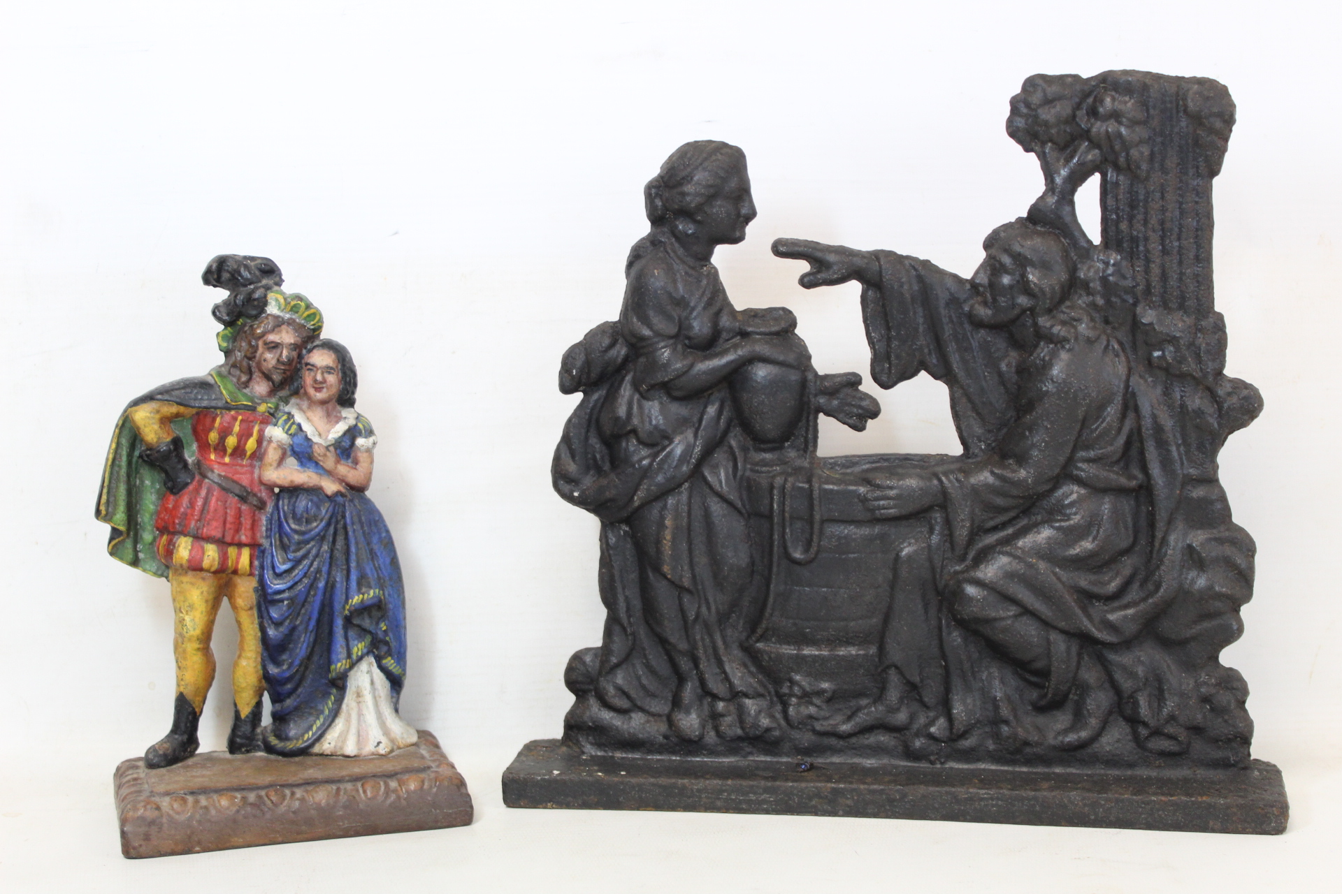 Victorian cast iron doorstop with biblical scene of Rebecca at the well, 26cm high and another of