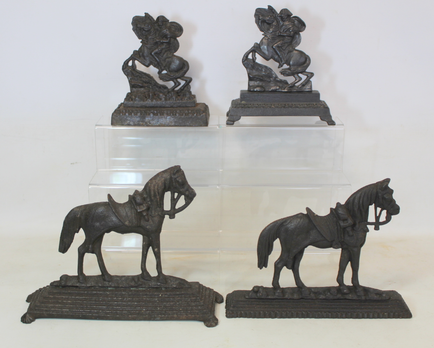 Two Victorian cast metal chimney ornaments depicting Napoleon crossing the Alps on horseback and two