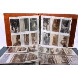 Two albums containing approximately 400 Edwardian and later postcards of topographical and other