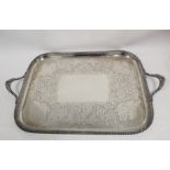 Good late Victorian silver tea tray, rectangular with rounded corners, embossed scrolls, flowers and