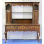18th century oak dresser,the open rail back flanked by two spice cupboards over three frieze