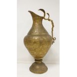 Large Indian brass ewer of baluster form with entwined double cobra handle and incised decoration