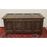 Antique oak coffer, the front with four carved panels, on stile supports. 133cm