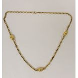 46cm chain link necklace with three applied granulated beads. Unmarked but tests as 9ct yellow gold.