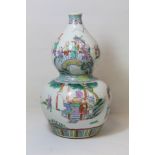 Chinese porcelain vase of double gourd form decorated in polychrome enamels and depicting figures at