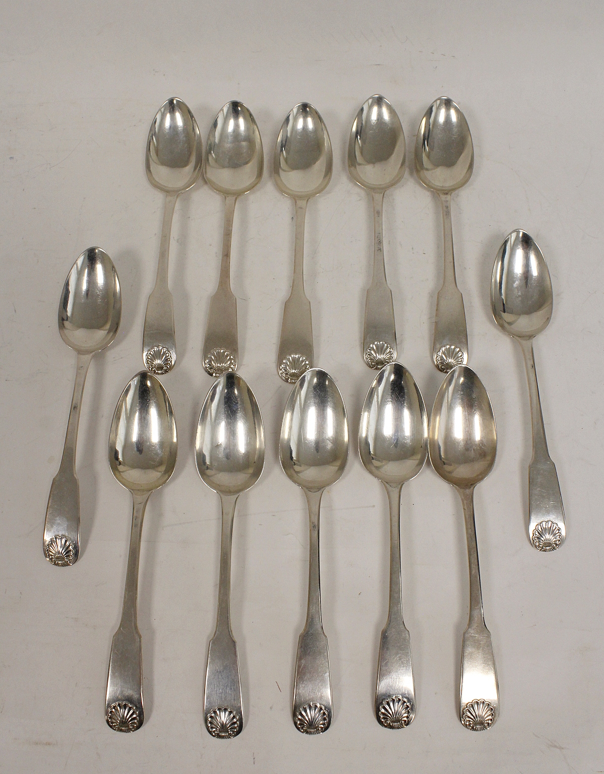 Set of twelve silver dessert spoons, fiddle and shell seven with mark P, struck separately four