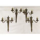 Set of four double sconce metal wall lights of tapered reeded form with urn finials, each 41cm high.