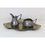 Three pieces of WMF Art Nouveau e.p. metalware comprising cream jug, sugar bowl and tray (rubbed)